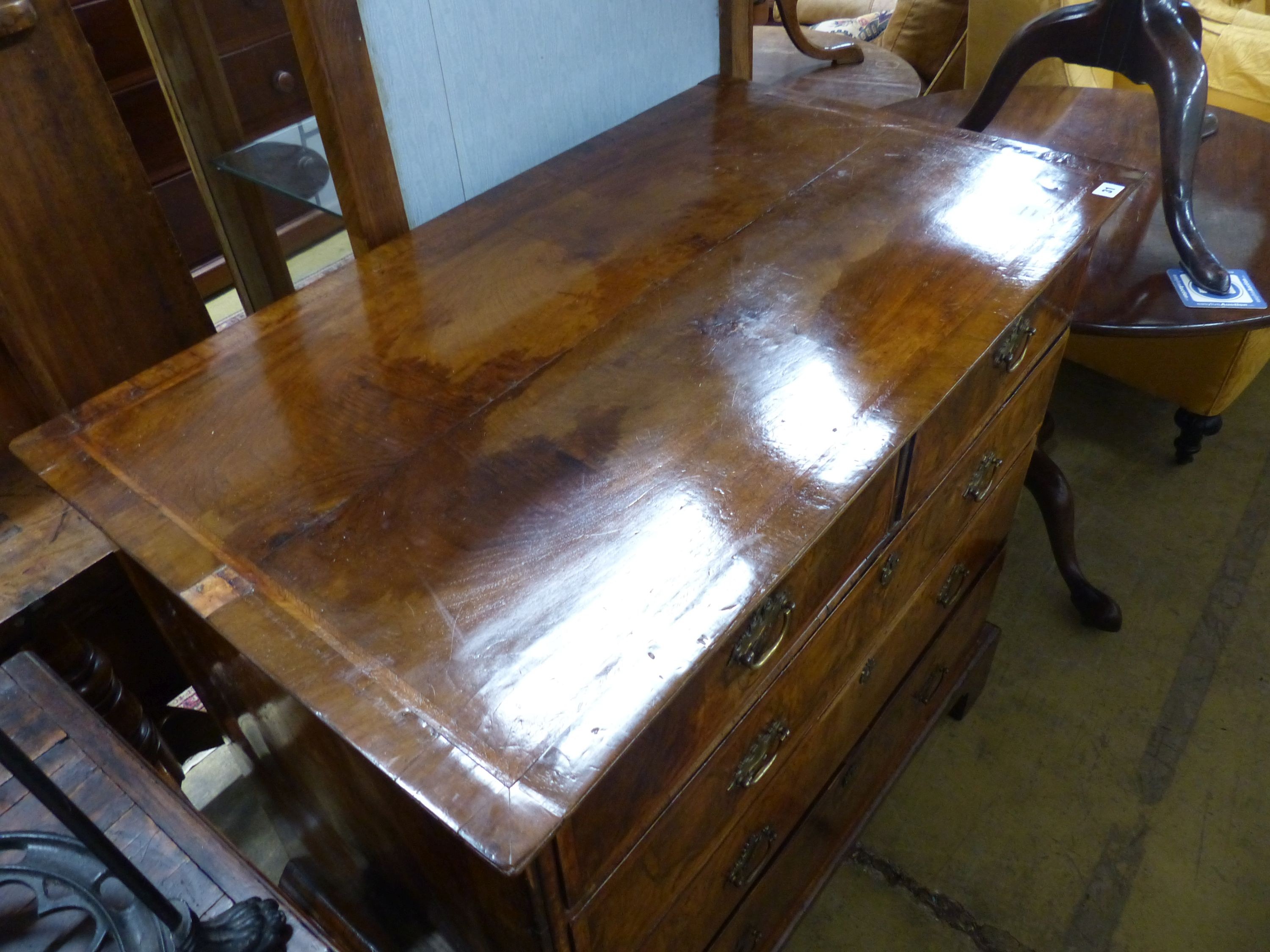 An 18th century crossbanded walnut chest of two short and three graduated long drawers, on bracket feet, W.99cm D.58cm H.94cm